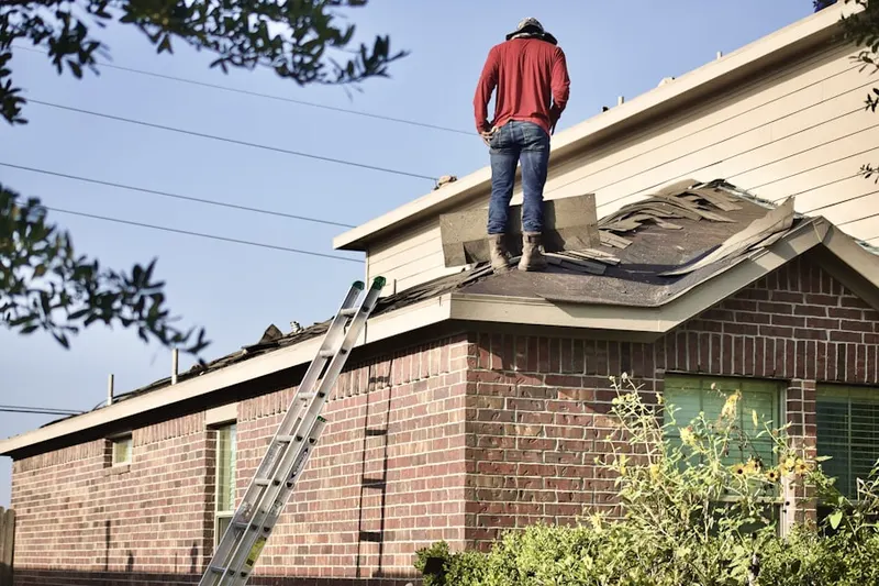 Professional roofer working on a residential roof in Muirfield Village